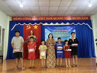 Bà Phạm Thị Thanh Hương - PCT. Hội Khuyến học huyện Hớn Quản trao học bổng cho các em tại buổi lễ.